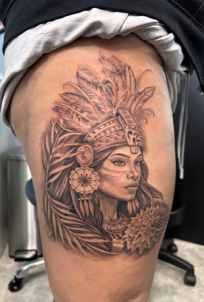 Large Aztec warrior princess portrait, woman with feather headdress. Mexican flower and ferns/leaves framing the face placed on the right thigh.