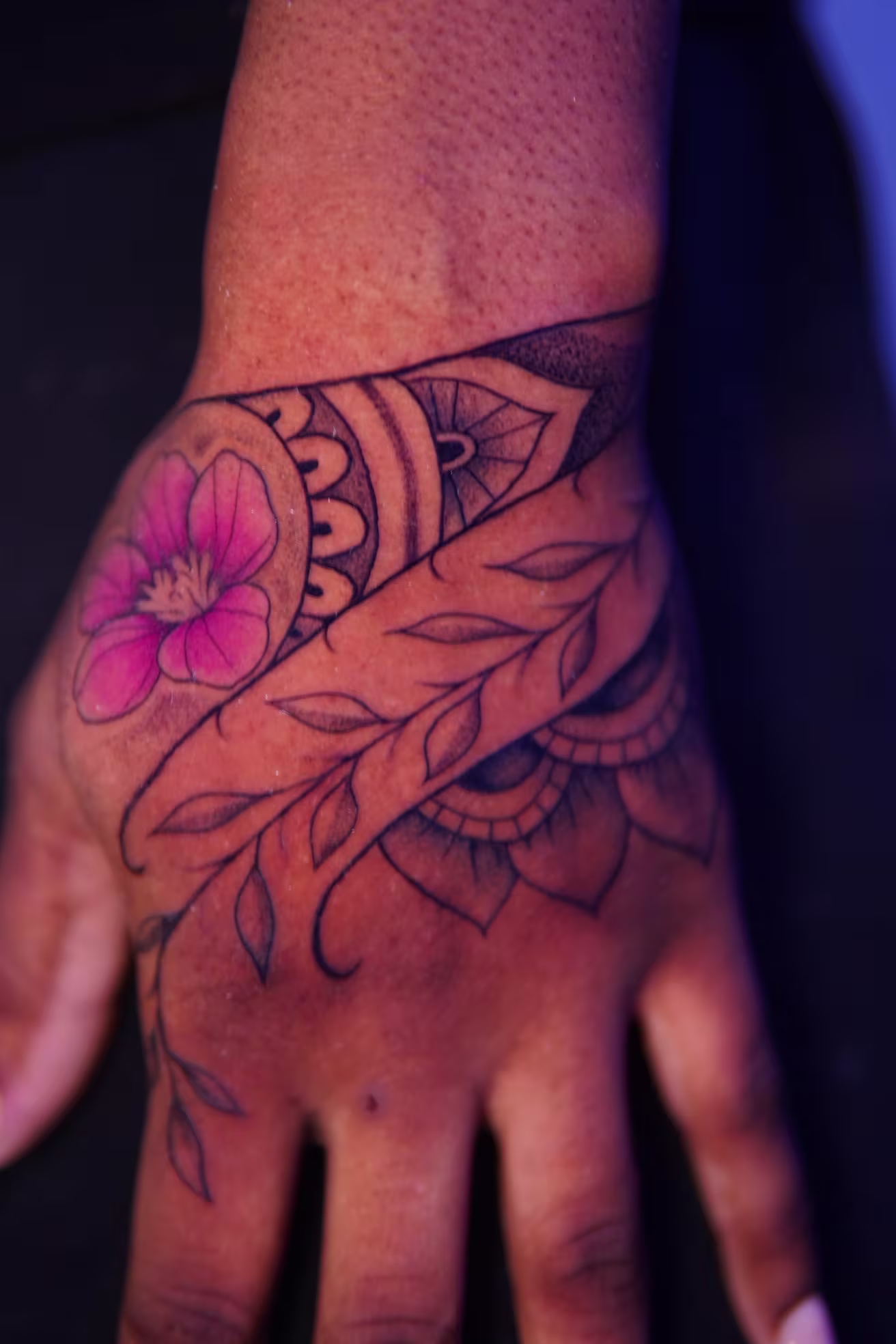 Mandala with leaves and a magenta on the left hand.