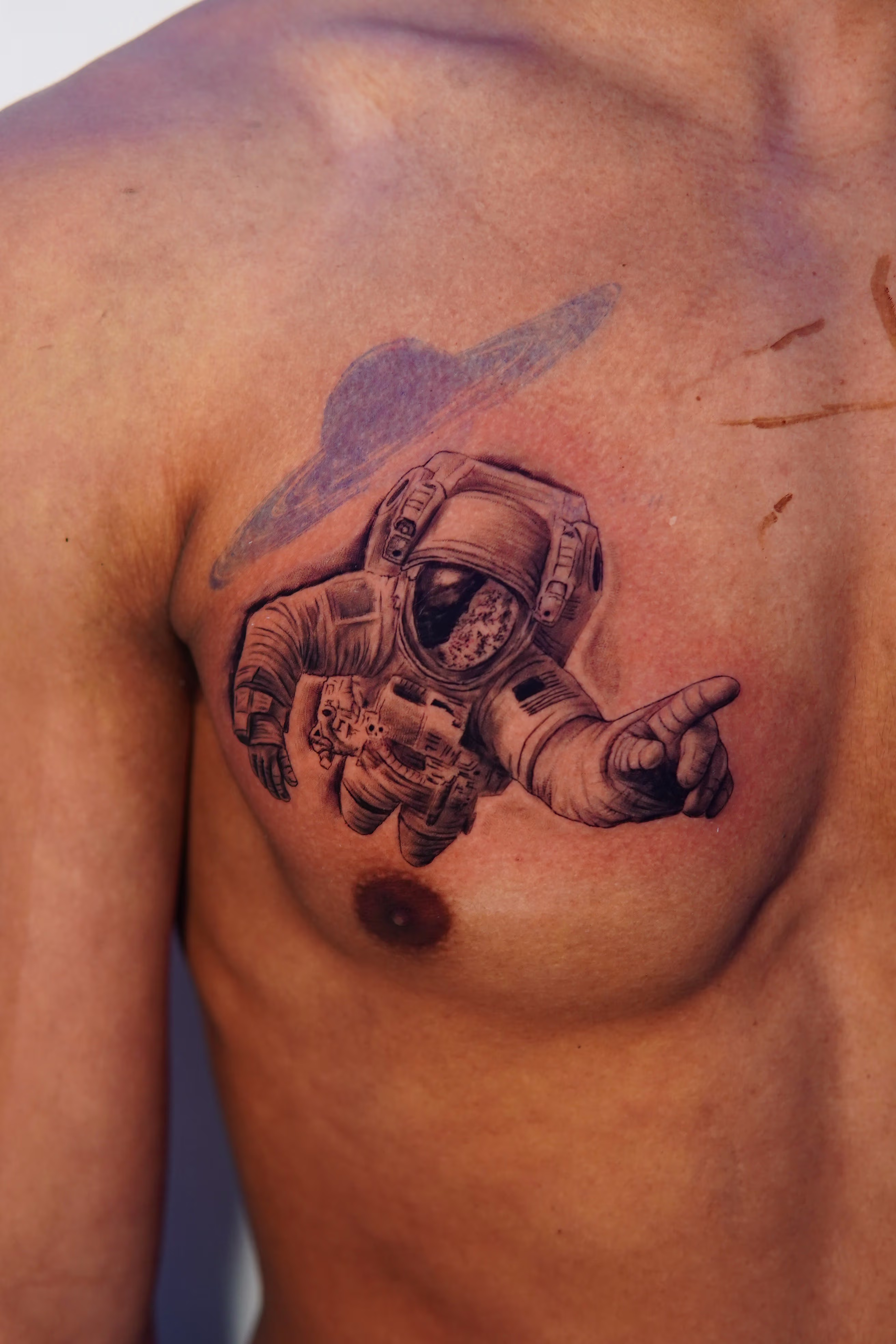 Realistic astronaut on the right pec.